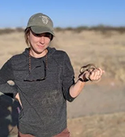 Annika holding snake in desert