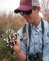 Kent holding snake in wild