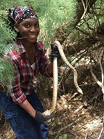 Lauren holding snake in forest