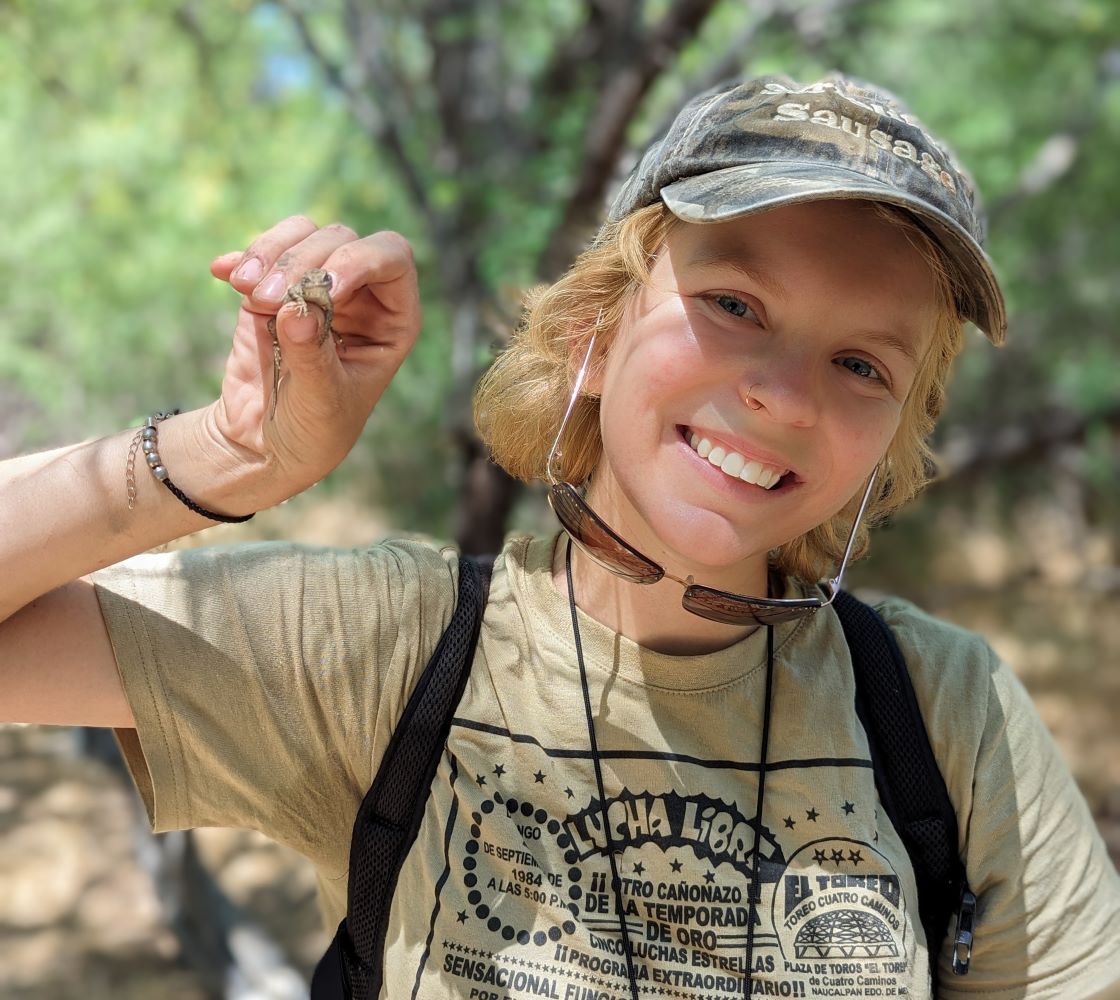 person holding lizard and smiling